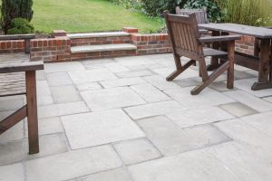 Modern patio in Sydney with natural stone pavers, demonstrating the elegance and practicality of using this stone for patios.