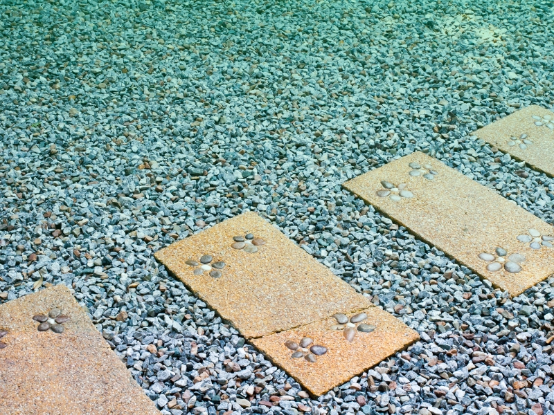 Decorative stone pathway on gravel as a practical pavement option for outdoor landscaping.