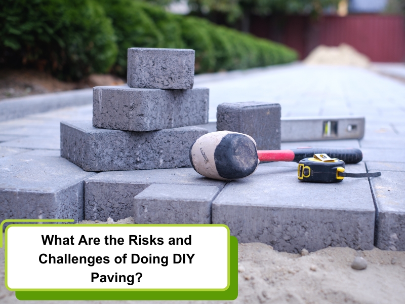 A close-up of pavers, a rubber mallet, and a spirit level on a DIY paving job.