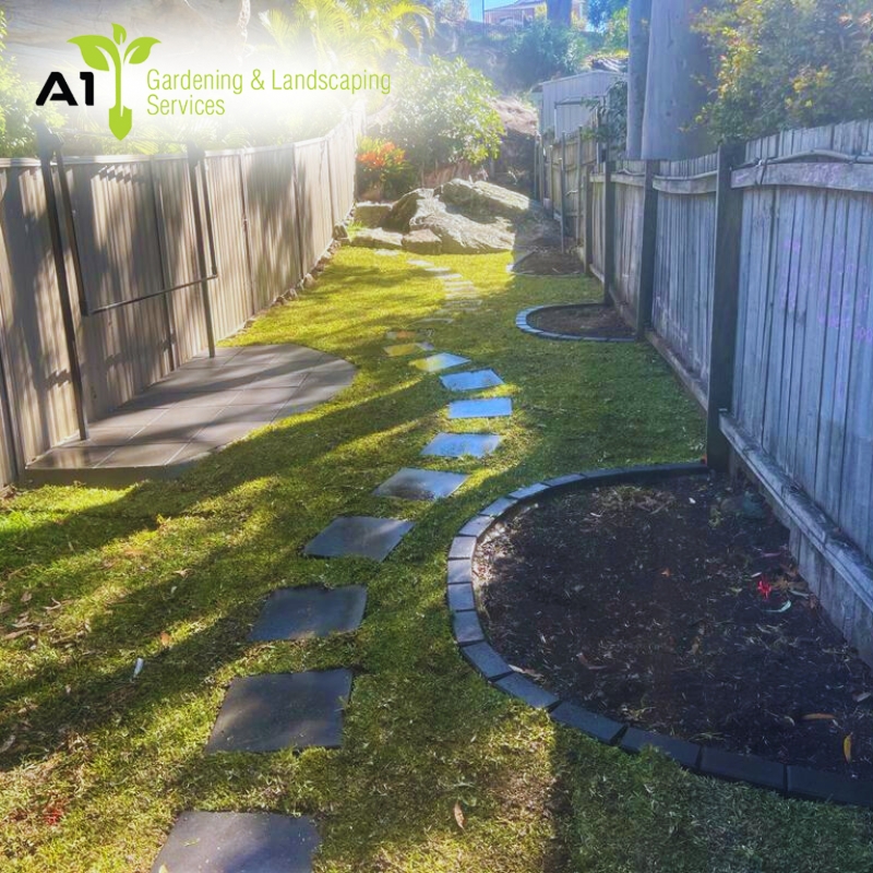 A serene garden featuring a central path surrounded by lush grass, showcasing well-maintained landscaping in Rouse Hill
