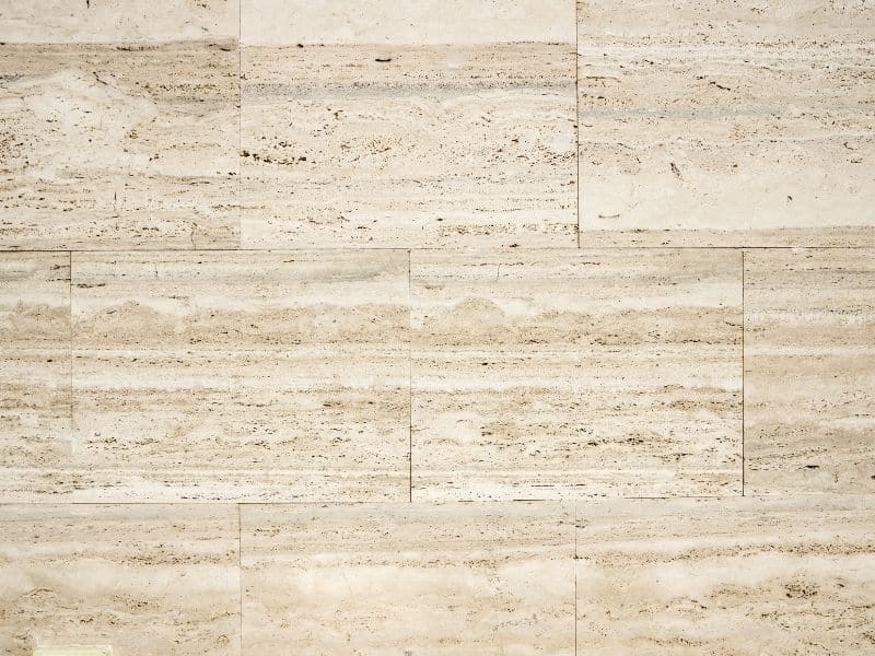 Travertine paving with light beige and cream tones featuring subtle horizontal veining patterns.