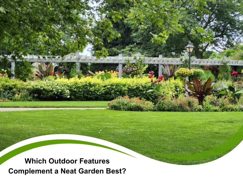 A spacious neat garden with manicured lawn, flowering borders, and a white pergola surrounded by vibrant plants.