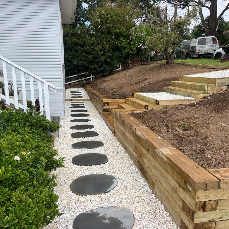 A sleeper or block retaining wall being built on a Sydney site.